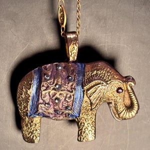 BB223 Bronze, brilliant bronze elephant with garnet eye, cubic zirconia gems, on 18” bronz intricate chain handmade, one of a kind,