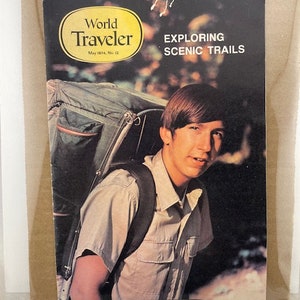 May include: A vintage magazine cover featuring a young man with a backpack, titled "World Traveler" and "Exploring Scenic Trails". The magazine is from May 1974.