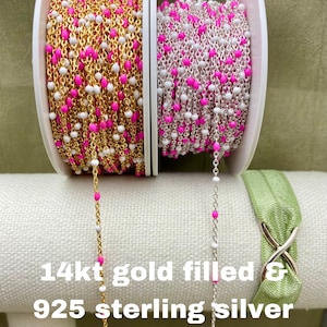 May include: Two spools of chain with pink and white beads. The chain on the left is 14kt gold filled and the chain on the right is 925 sterling silver.