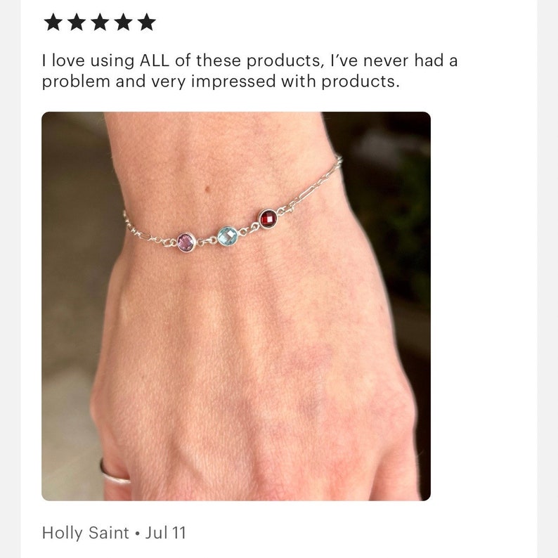May include: A delicate silver bracelet featuring three colorful gemstones: a purple, a light blue, and a deep red. The bracelet is worn on a wrist. The text in the image says "I love using ALL of these products, I've never had a problem and very impressed with products."