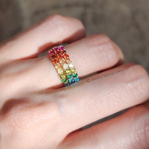 ring, eternity band, stacking ring, pink ruby, red and orange garnet, yellow citrine, light green peridot, green emerald, blue topaz, purple amethyst, round stones, silver, yellow gold, rose gold