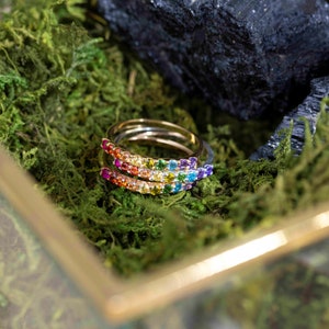 ring, eternity band, stacking ring, pink ruby, red and orange garnet, yellow citrine, light green peridot, green emerald, blue topaz, purple amethyst, round stones, silver, yellow gold, rose gold