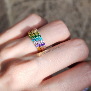 ring, eternity band, stacking ring, pink ruby, red and orange garnet, yellow citrine, light green peridot, green emerald, blue topaz, purple amethyst, round stones, silver, yellow gold, rose gold