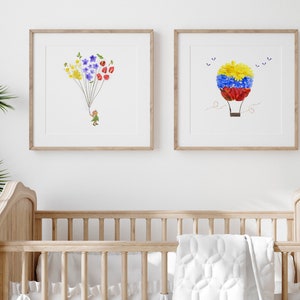 May include: Two framed prints with floral designs. The first print features a girl holding a bunch of colorful flowers, while the second print shows a hot air balloon made of flowers.