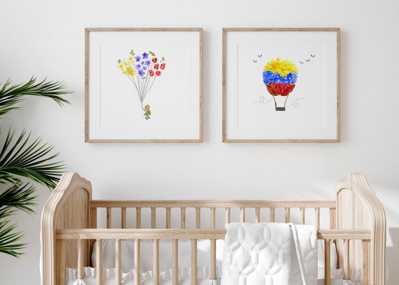 May include: Two framed prints with floral designs. The first print features a girl holding a bunch of colorful flowers, while the second print shows a hot air balloon made of flowers.