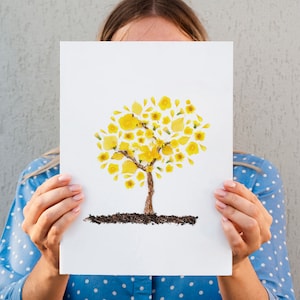 woman holding a print of an Araguaney