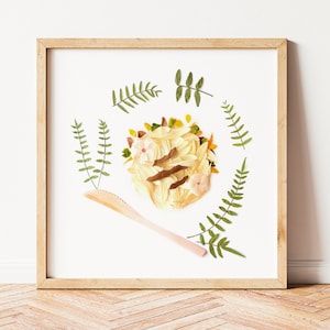 May include: A framed artwork featuring a circular arrangement of dried flowers and leaves in shades of green, yellow, and pink. A wooden stick is placed diagonally across the artwork.