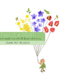May include: A print of a whimsical illustration featuring a small figure holding a bunch of colorful flowers, including yellow, blue, and red, that are arranged to look like a bouquet of balloons. The text "THIS IS A PRINT" and "The original composition was made with flowers and/or leaves" is displayed at the top of the image. The text "FRAME NOT INCLUDED" is displayed at the bottom of the image.