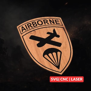 Könnte beinhalten: Holzschild mit dem Wort "AIRBORNE" oben. Das Schild zeigt ein schwarzes Flugzeug und ein Fallschirmdesign. Der Text "SVG | CNC | LASER" befindet sich unten. Das Schild ist schildförmig mit hellbrauner Holzmaserung.