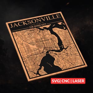 Puede incluir: Mapa de madera de Jacksonville, Florida, con el nombre de la ciudad y las coordenadas grabadas en negro. El mapa destaca el río St. Johns y sus alrededores. También se incluye el texto "THE RIVER CITY". El texto "SVG | CNC | LASER" está presente.