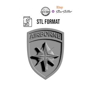 May include: A gray shield-shaped emblem with the word "AIRBORNE" at the top. A starburst design is in the center. The image also includes the text "STL FORMAT" and the Etsy Star Seller logo.