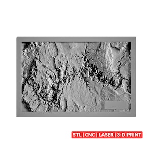 May include: A rectangular gray 3D relief map featuring detailed topographical terrain with deep valleys and ridges. The map is framed in a solid gray border and includes a small rectangular blank space in the lower right corner. Text below reads: STL | CNC | LASER | 3-D PRINT.