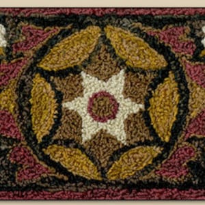 May include: A brown, white, and burgundy rug with a geometric pattern of leaves and flowers. The rug has a black border.