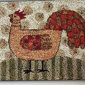May include: A decorative rug featuring a rooster design. The rooster has a brown body, a red comb and tail, and black legs. The background is a mix of beige and green, creating a rustic, country-style aesthetic. The rug is rectangular.