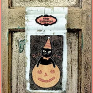May include: A vintage Halloween card with a black cat wearing a witch's hat and holding a pumpkin. The card says "Happy Halloween" and "Boo".