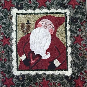 May include: A Christmas-themed rug featuring a central image of Santa Claus in a red suit with a white beard and a heart. The rug is framed by a white scalloped border and surrounded by red stars and green foliage.