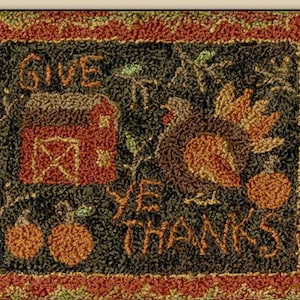 May include: A brown and green rug with a red barn, a turkey, and pumpkins. The text "Give Ye Thanks" is embroidered on the rug.