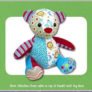 May include: A colorful patchwork soft toy bear with a red nose, blue, red, and white striped arms, and a blue and white polka dot body. The bear is 12 inches tall and is made of fabric.
