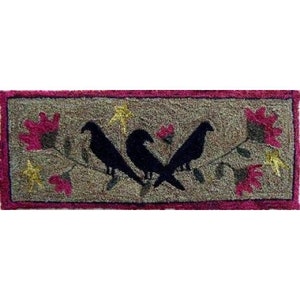 May include: Rectangular rug with a tan background and a dark pink border. Three black birds are perched on a branch with pink and yellow flowers. The rug has a textured appearance.