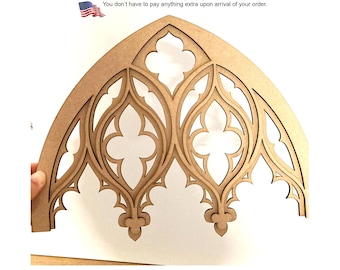 May include: A light brown, laser-cut wooden panel featuring an intricate, symmetrical gothic arch design with pointed arches and quatrefoil cutouts. The decorative piece has a smooth, flat surface and a complex, repeating architectural pattern.