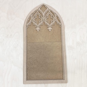 May include: A wooden cutout of a gothic archway with intricate details. The archway is made of light brown wood and has a natural finish. The archway is perfect for adding a touch of gothic style to any home decor project.