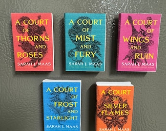 May include: Five paperback books with colorful covers featuring a court of thorns and roses, a court of mist and fury, a court of wings and ruin, a court of frost and starlight, and a court of silver flames. Each book cover features a different illustration and the text "A Court of..." and "Sarah J. Maas".