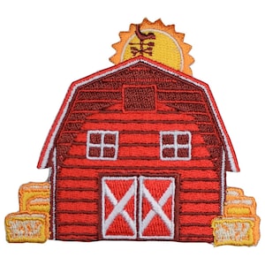 May include: Red barn with a yellow sun on top and hay bales on either side. The barn has two windows and a double door with a white X pattern.