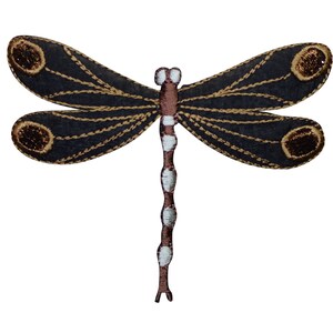 May include: A black and brown embroidered dragonfly with white accents. The dragonfly has two pairs of wings and a long, segmented body.