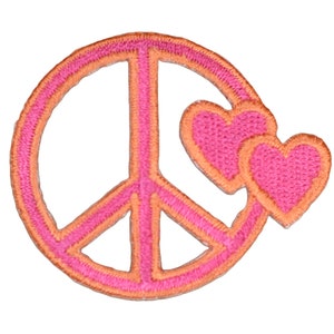 May include: A circular peace sign patch featuring bright pink embroidery with a vibrant orange border. Two small, matching pink heart-shaped patches with orange borders are attached to the right side of the circular peace symbol frame.