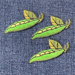 May include: Three green pea pod patches with yellow leaves. The pea pods are embroidered with white stitches to represent the peas inside.