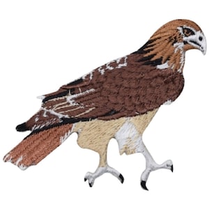 May include: Embroidered patch of a brown and white hawk with its wings spread out. The hawk is standing on its feet with its head turned to the right.