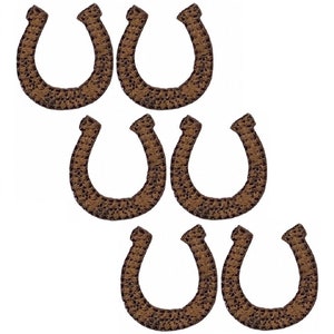 May include: Nine brown felt horseshoe patches. The patches are about 1 inch wide and 1.5 inches tall.