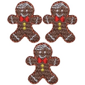 May include: Three brown gingerbread man iron-on patches with red bow ties and white icing details.