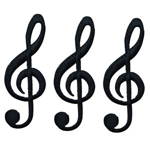 May include: Three black embroidered treble clef music note patches.
