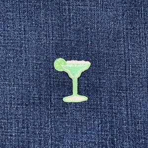 May include: A light green margarita cocktail patch with a lime wedge, set against a blue denim background. The patch is a fun, decorative item, perfect for adding to clothing or accessories.