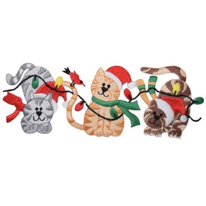 May include: Three embroidered cats wearing Santa hats and scarves are holding a string of Christmas lights. A red cardinal is perched on a branch of the lights.