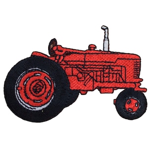May include: Embroidered patch featuring a red tractor with black tyres and a silver exhaust pipe. The tractor is shown in profile with detailed stitching. The patch is likely for clothing or accessories.