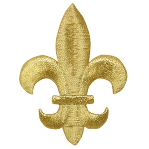 May include: A gold-colored fleur-de-lis emblem, featuring a three-petal design with curved side elements. The emblem has a textured, embroidered appearance, and is set against a plain white background.