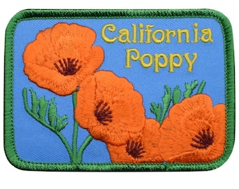 May include: A rectangular embroidered patch with a light blue background featuring three orange California poppy flowers with green stems and leaves. The text California Poppy is embroidered in yellow script in the upper right corner.