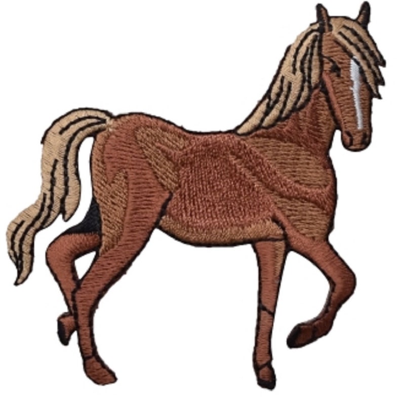 May include: A brown horse with a light brown mane and tail. The horse is standing on all four legs and is facing to the right. The horse has a white stripe on its face.
