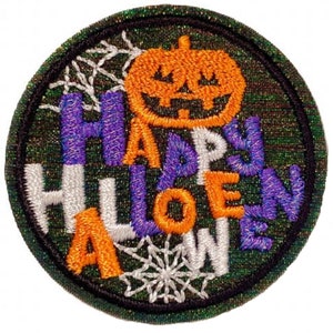 May include: A round, green, embroidered patch with a white, orange, and purple "Happy Halloween" message. A jack-o-lantern with an orange face is above the text. White spiderwebs are in the background.