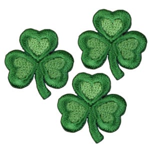 May include: Three green shamrock patches with embroidered details.