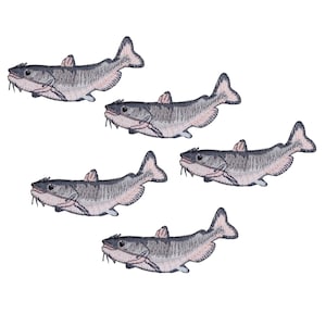 May include: Five embroidered catfish patches arranged in a scattered pattern. Each fish features a dark grey back, a light pinkish-white underbelly, visible whiskers, and detailed fin stitching, all presented against a plain white background.