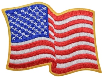 May include: A red, white, and blue American flag patch with a gold border. The flag is waving in the wind.