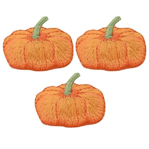 May include: Three orange felt pumpkins with green stems. The pumpkins are stitched with a textured pattern.