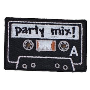 May include: Black cassette tape patch with the words "party mix!" in white. The patch has a white border and silver accents, with the letter "A" visible. The design mimics a classic audio cassette.