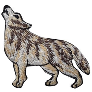May include: Embroidered patch of a brown and white wolf howling at the moon. The wolf is standing on all fours with its head tilted back and its mouth open.