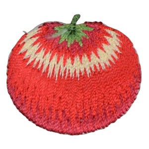 May include: A red embroidered tomato with a green stem and white accents. The tomato is a decorative patch for sewing or crafting.