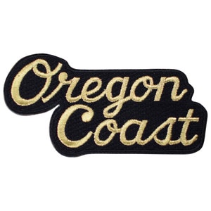 May include: Gold embroidered patch with the text "Oregon Coast" on a black background.