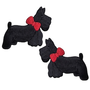 May include: Two black felt iron-on patches of Scottish Terriers wearing red bow ties.